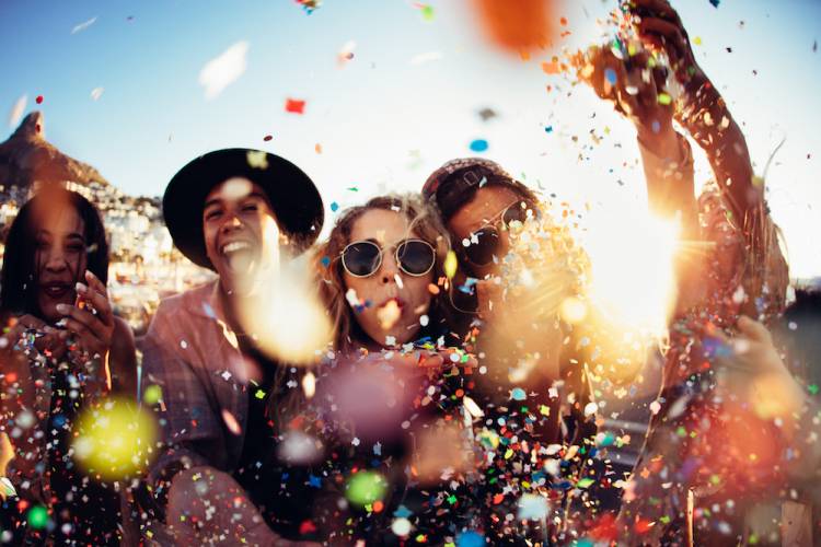 confetti falling in front of young people at an outdoor festival