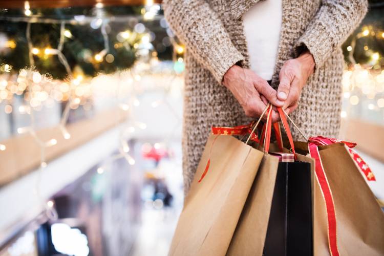 woman holding holiday shopping bags
