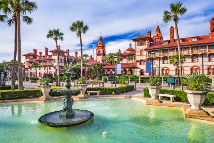 lighner museum in downtown st augustine florida with bright blue water, palm trees and blue skies